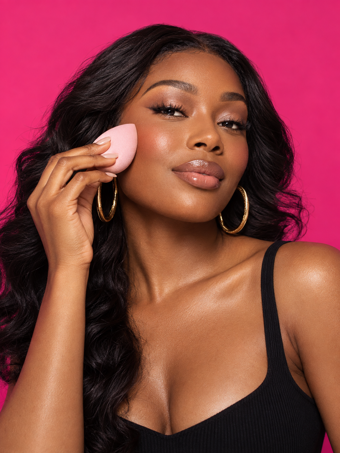 Woman applying makeup with a Nuche beauty sponge